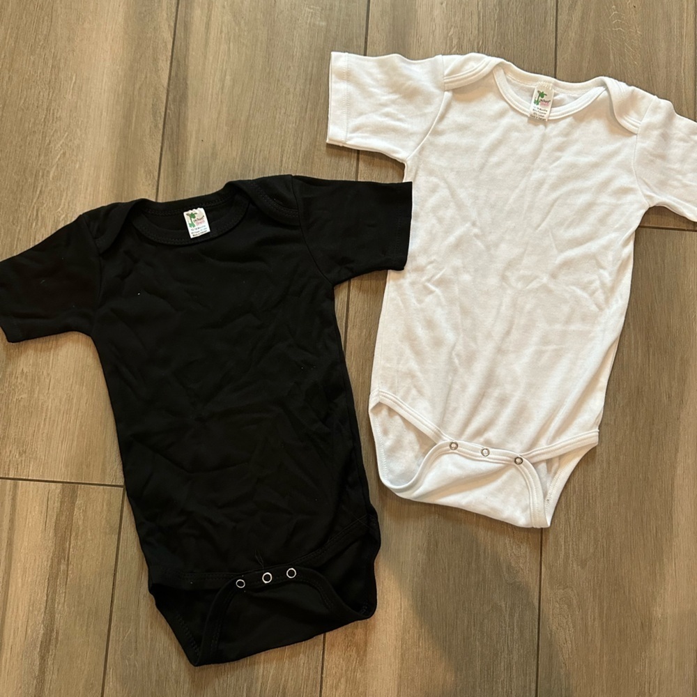 White and black onesie. Never been used.